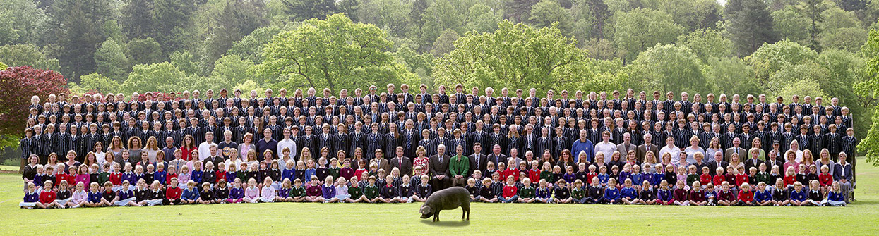 Whole school photograph with a pig standing in front of the group!