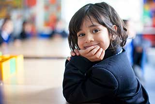 Photograph of pupil sitting at desk